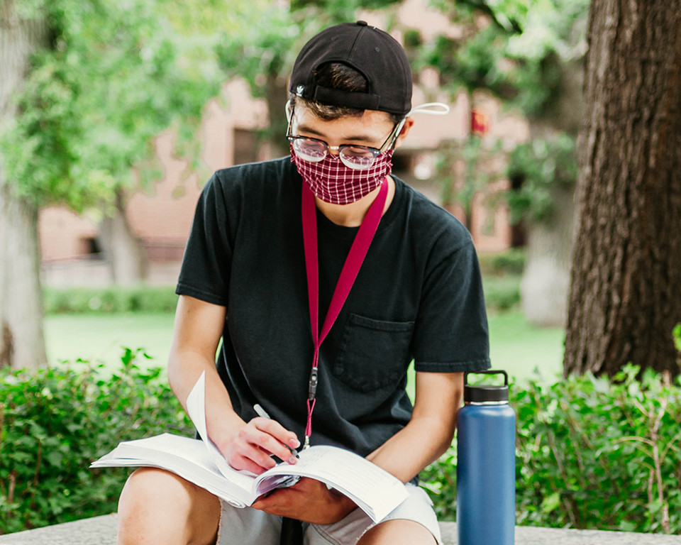 man wearing mask on campus